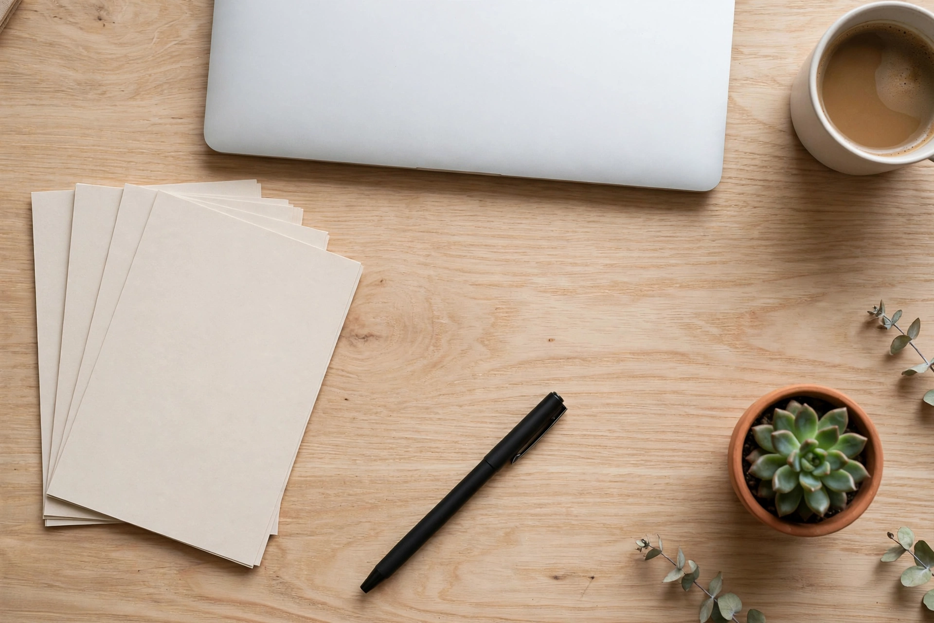Overhead flat lay of an organized digital-planning workspace with laptop, to-do cards, and coffee